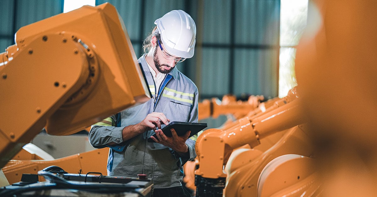 Industrial worker with tablet and helmet